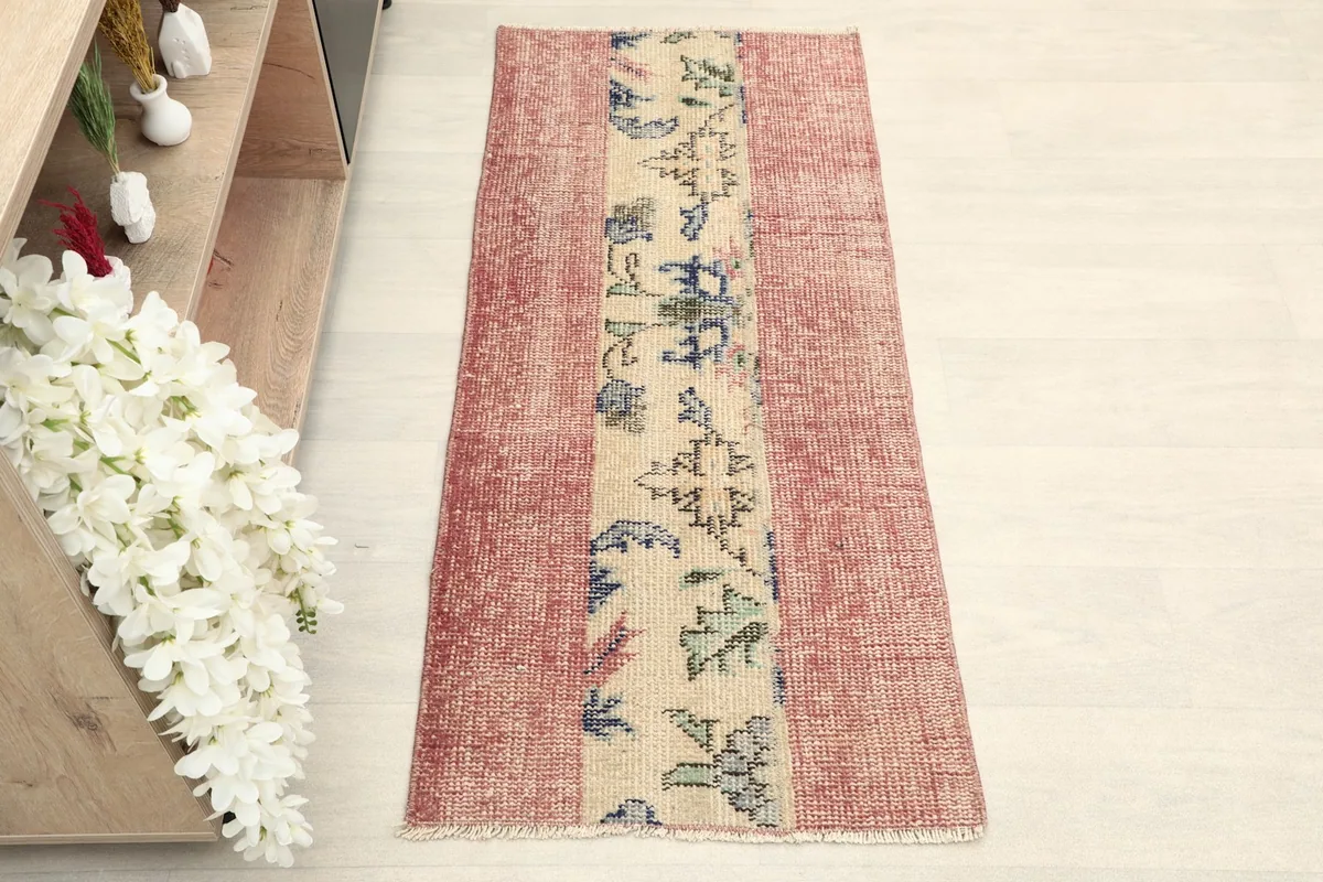 Overhead view of the vintage Anatolian rug with its rose field and central beige panel