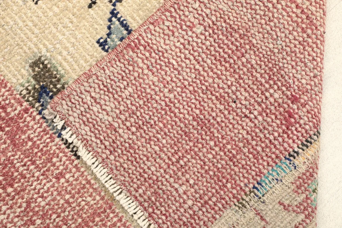 Close-up showing the low wool pile and the hand-knotted texture of the rug.