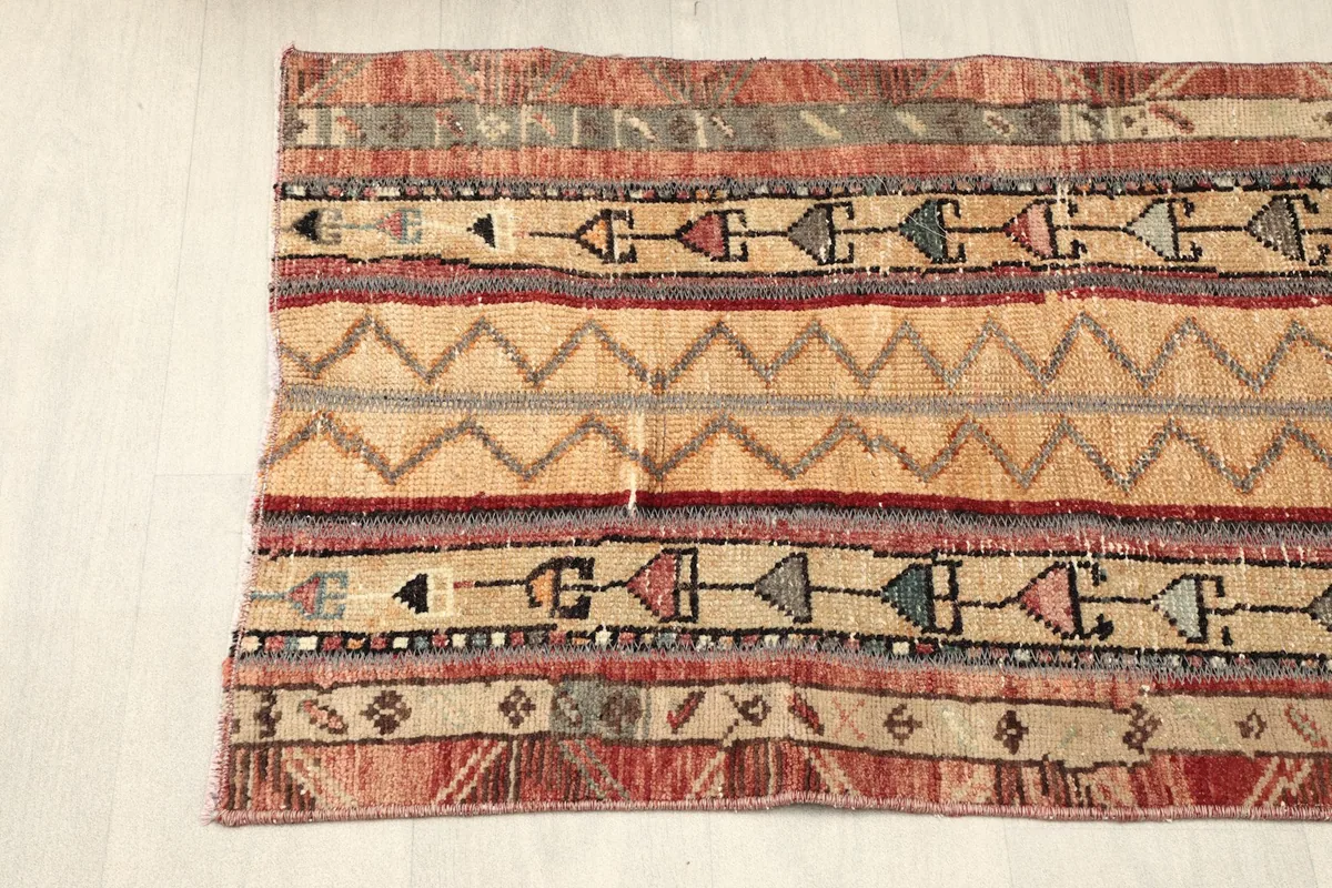 Angled view from one end of the rug, showing the full width and the distinct striped design.