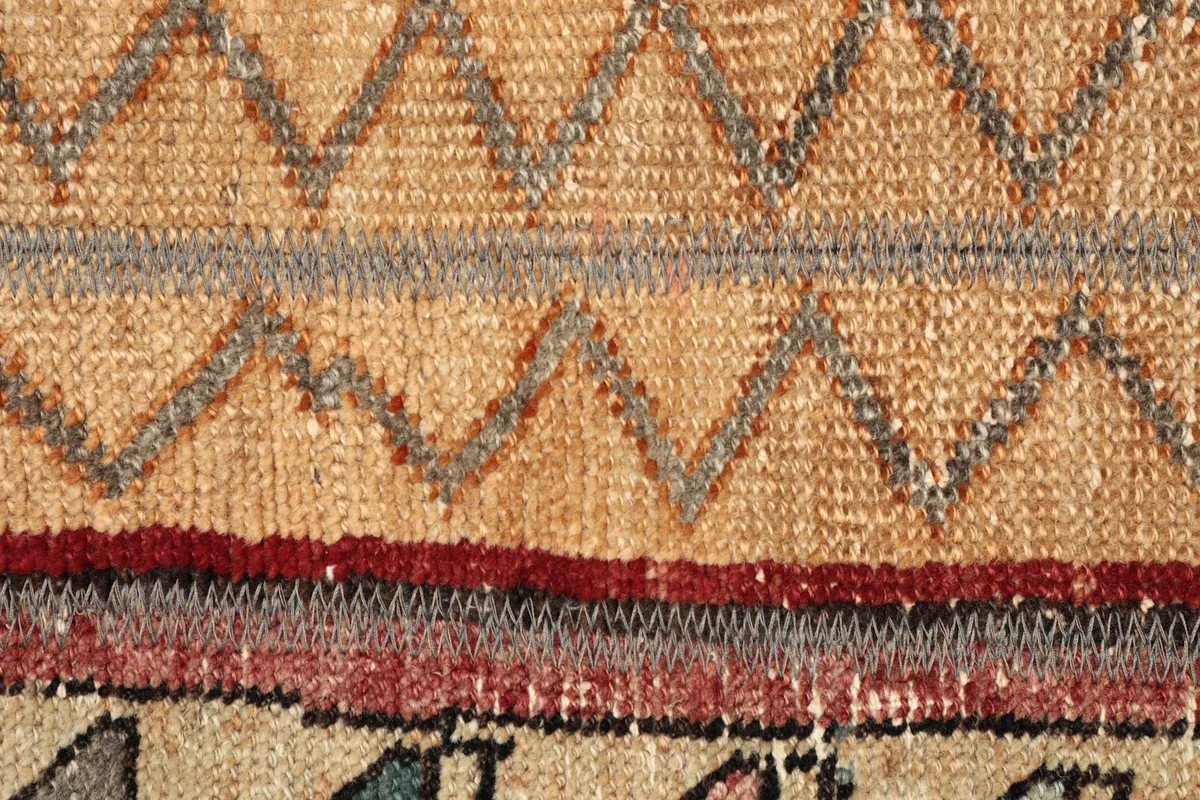 Extreme close-up of the low wool pile texture and the intricate weaving of the striped pattern.