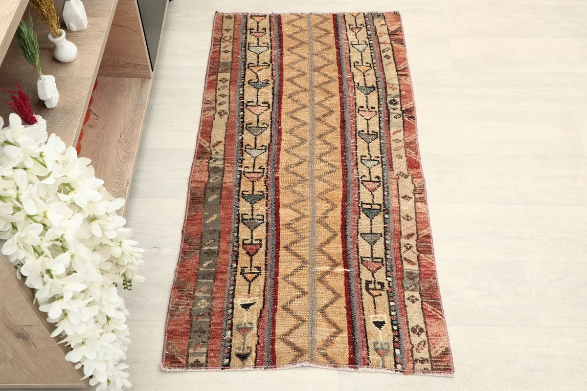 Overhead view of the vintage Anatolian rug, highlighting its striped pattern and color variations.