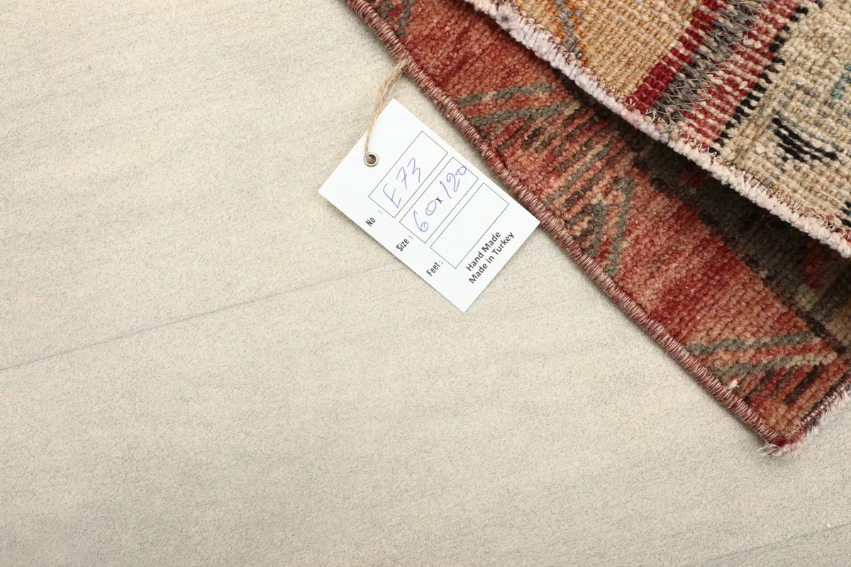 Corner of the rug with a tag showing '60x120 cm' dimensions, confirming its Anatolian origin.