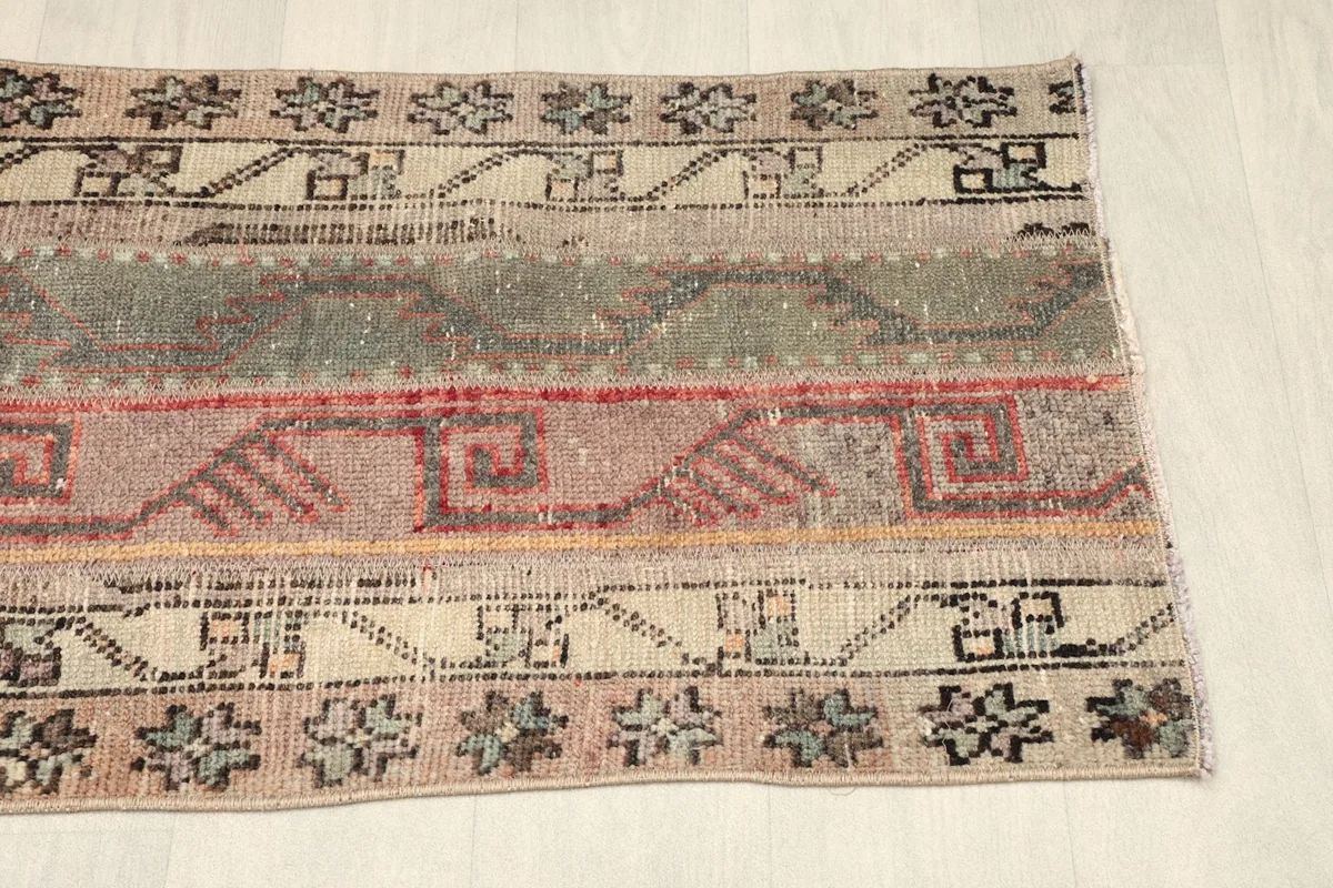 Lower section of the rug viewed from an angle, showing the consistent striped and patterned design.