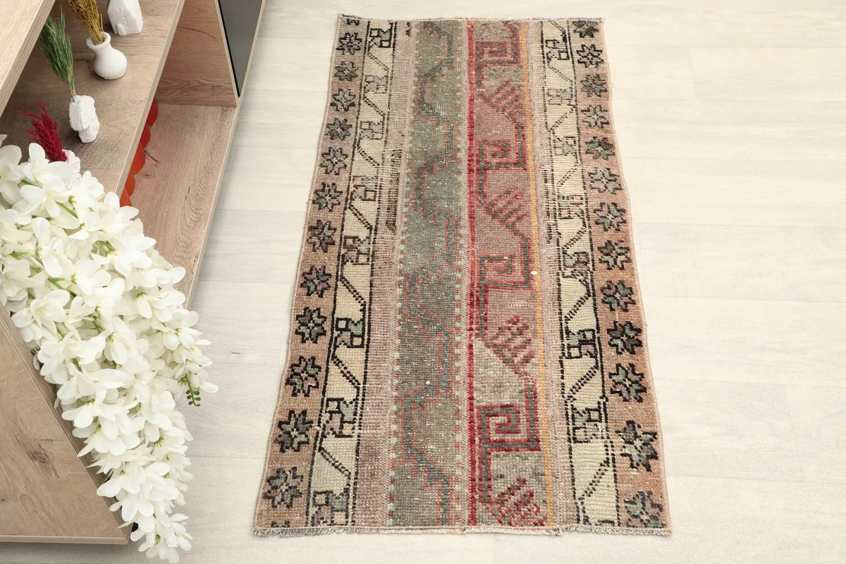 Top-down view of the hand-knotted vintage rug, showcasing its full pattern and colors.