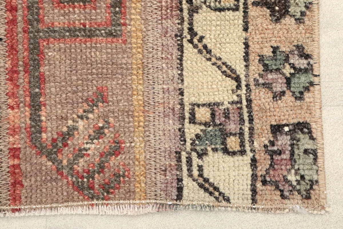 Close-up detail of the rug's surface, highlighting the various panels and textures.