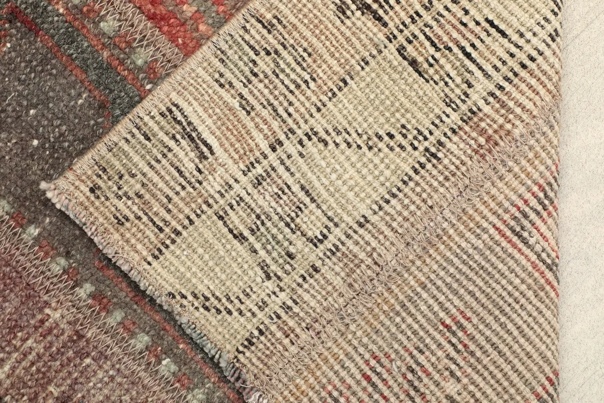 View of the back of the hand-knotted rug, showing the cotton foundation and knotting.