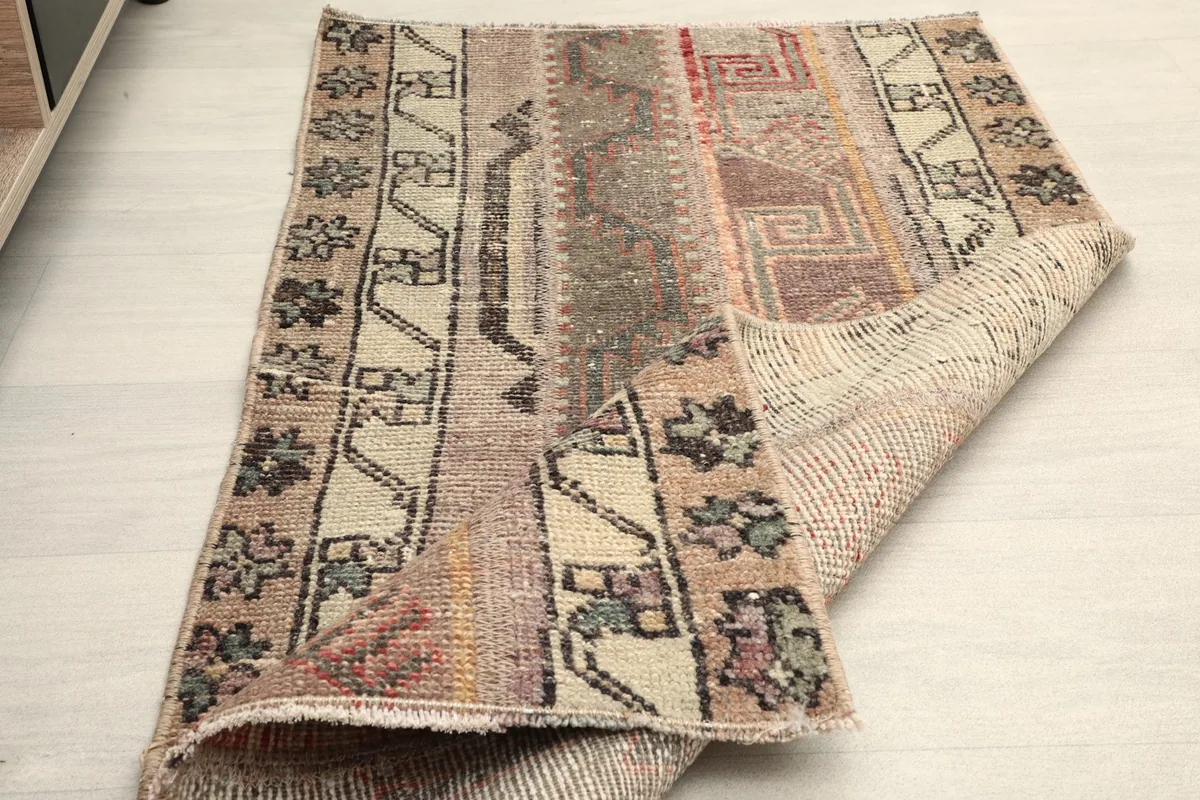 The rug partially folded, illustrating its flexibility and construction.