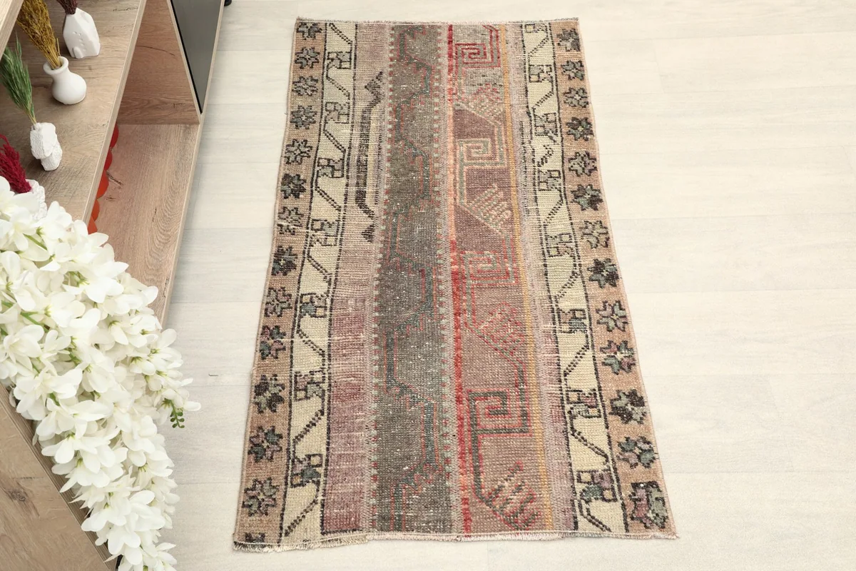 Overhead view of the hand-knotted wool rug, showing its full length and patchwork design.