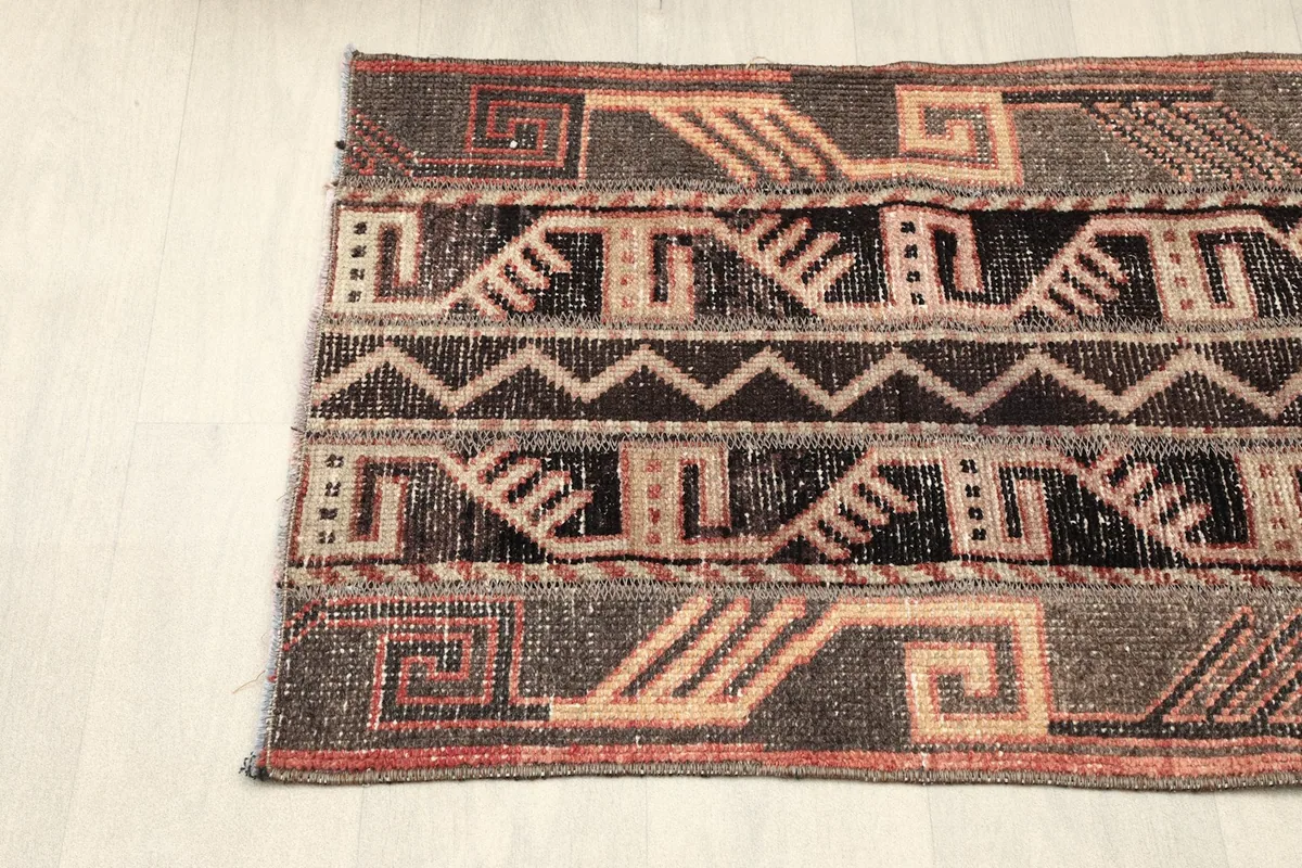 Angled shot of one end of the rug, showcasing the border and central design elements.