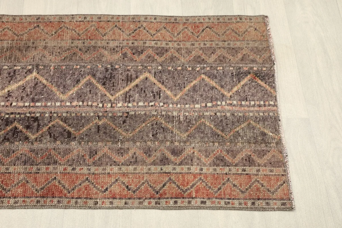 Another angled view of the rug, showing the full width of its patterned stripes.