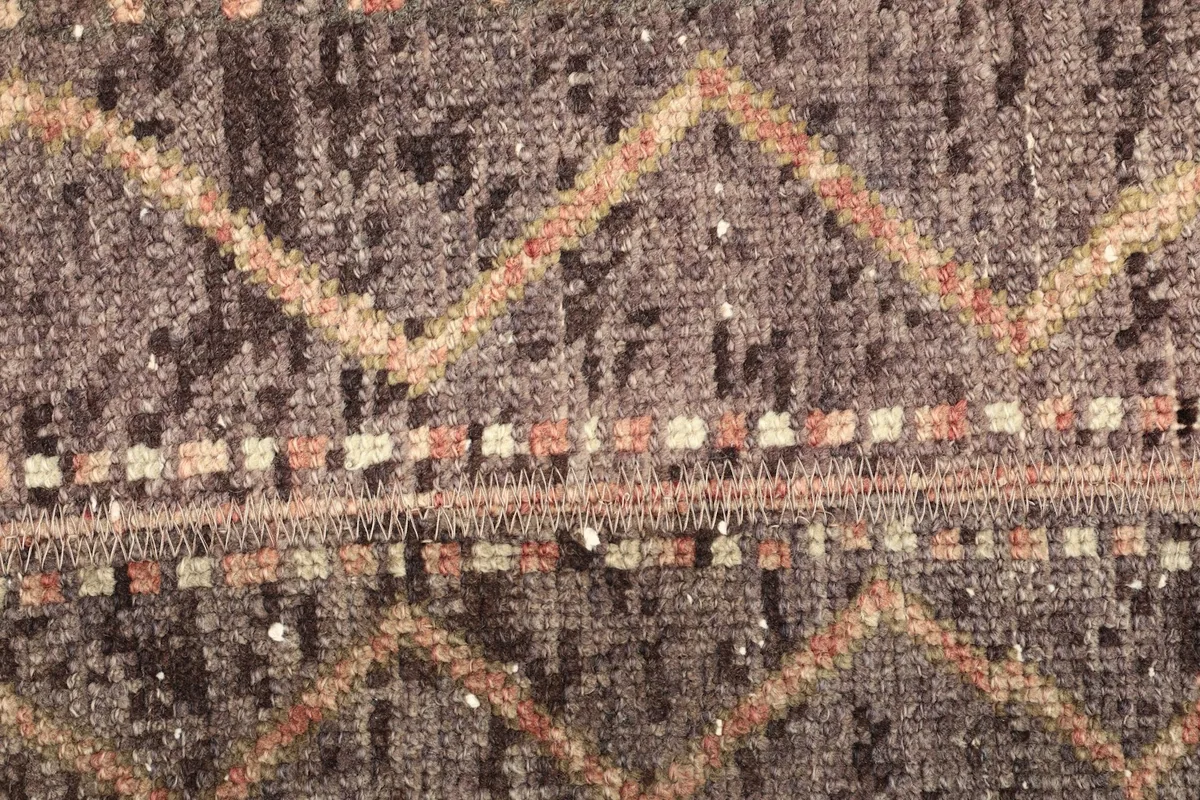 Detailed view of the intricate tribal motifs and color variations in the rug's pile.