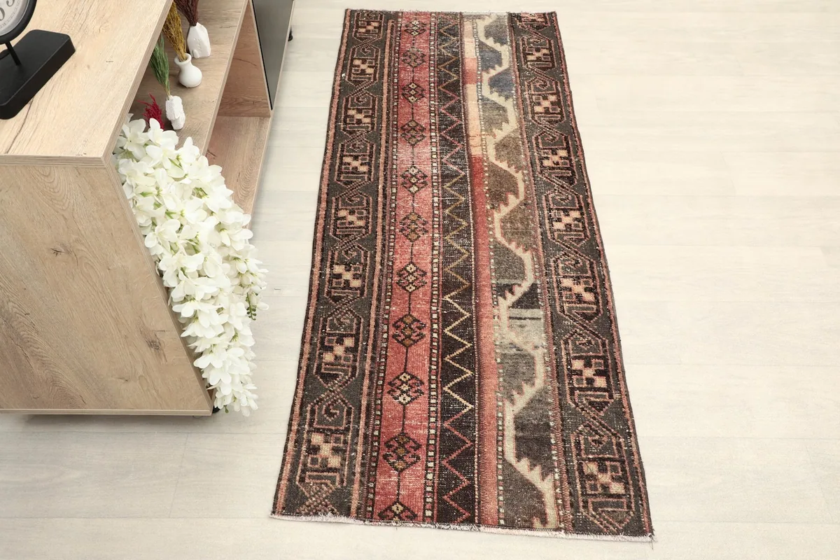 Vintage Anatolian runner rug displayed in a room setting with a light-colored floor