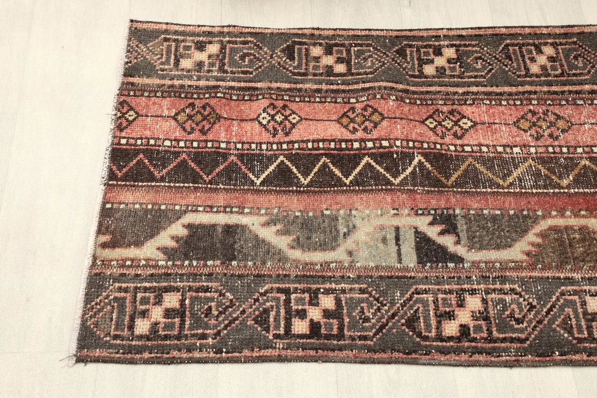Close-up of the upper half of the rug showing geometric patterns and color variations