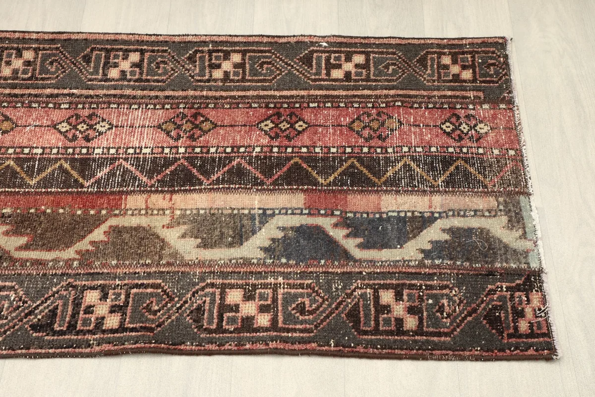 Close-up of the lower half of the rug, detailing the blue and gray sections within the stripes
