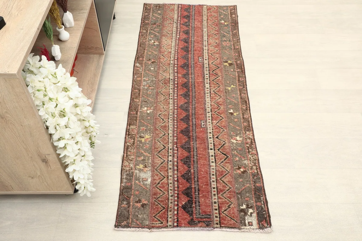 Direct overhead shot of the hand-knotted runner, highlighting its full length and striped geometric patterns.