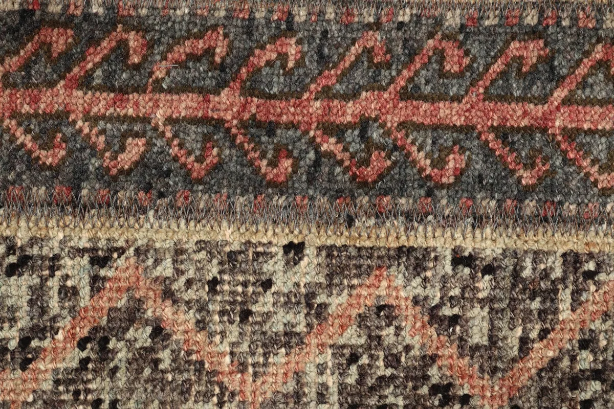 Detailed view of the specific rust-colored wavy and geometric patterns within a striped band.