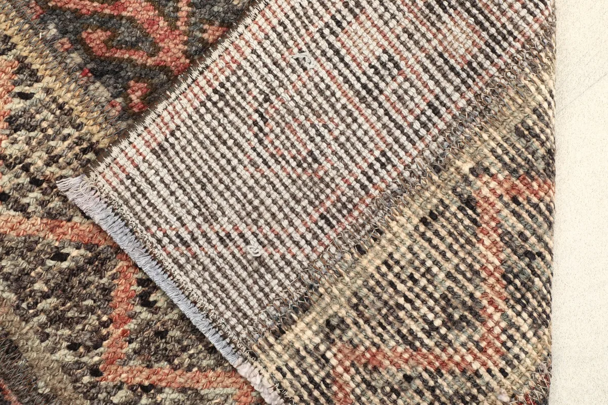 View of the back of the hand-knotted wool rug, showing the cotton foundation and knotting.