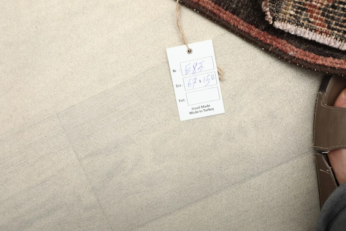 Close-up of the product tag indicating the rug's dimensions and origin from Turkey.