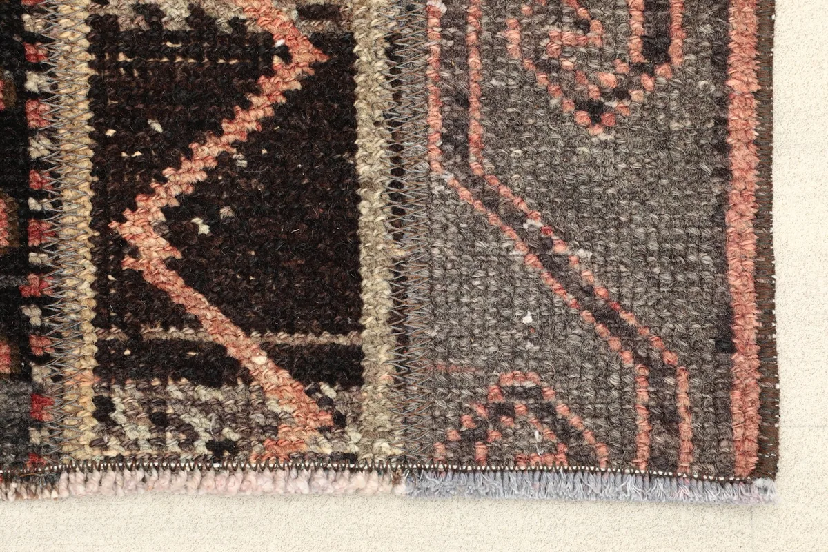 Close-up detail of the rug's edge, showing the intricate hand-knotting and texture
