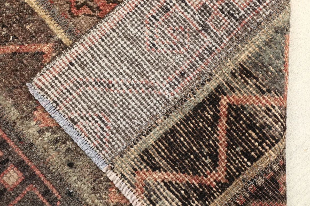 Close-up of the rug's back, revealing the cotton foundation and hand-knotted construction