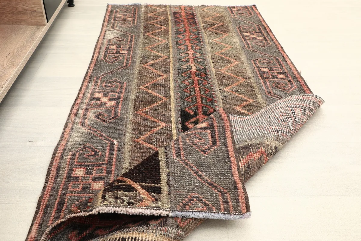 The rug partially folded, showing its flexibility and pile texture