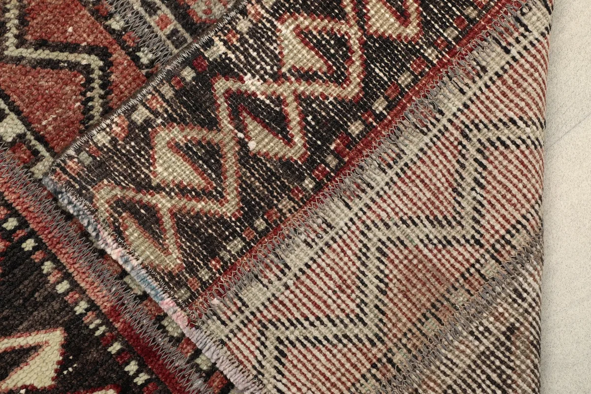 Close-up of the back of the hand-knotted rug, revealing the intricate weaving and cotton foundation.