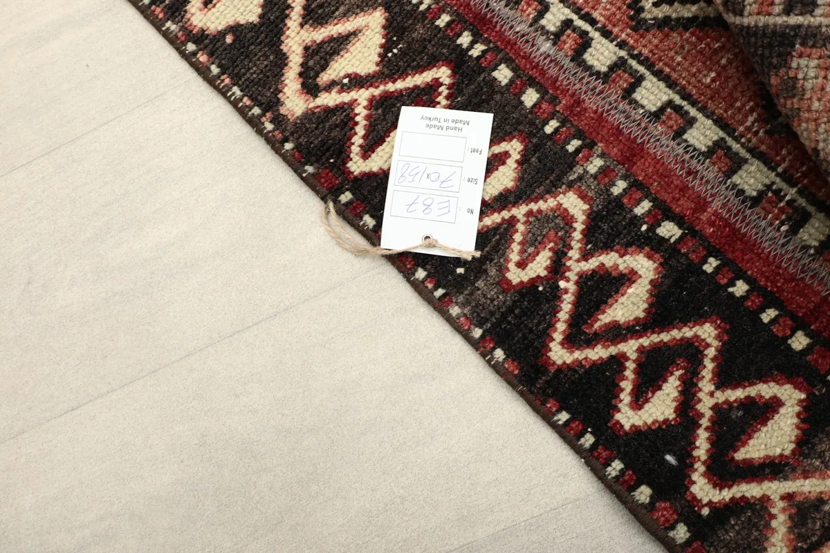 Corner of the rug with a product tag, showing the quality and origin details.