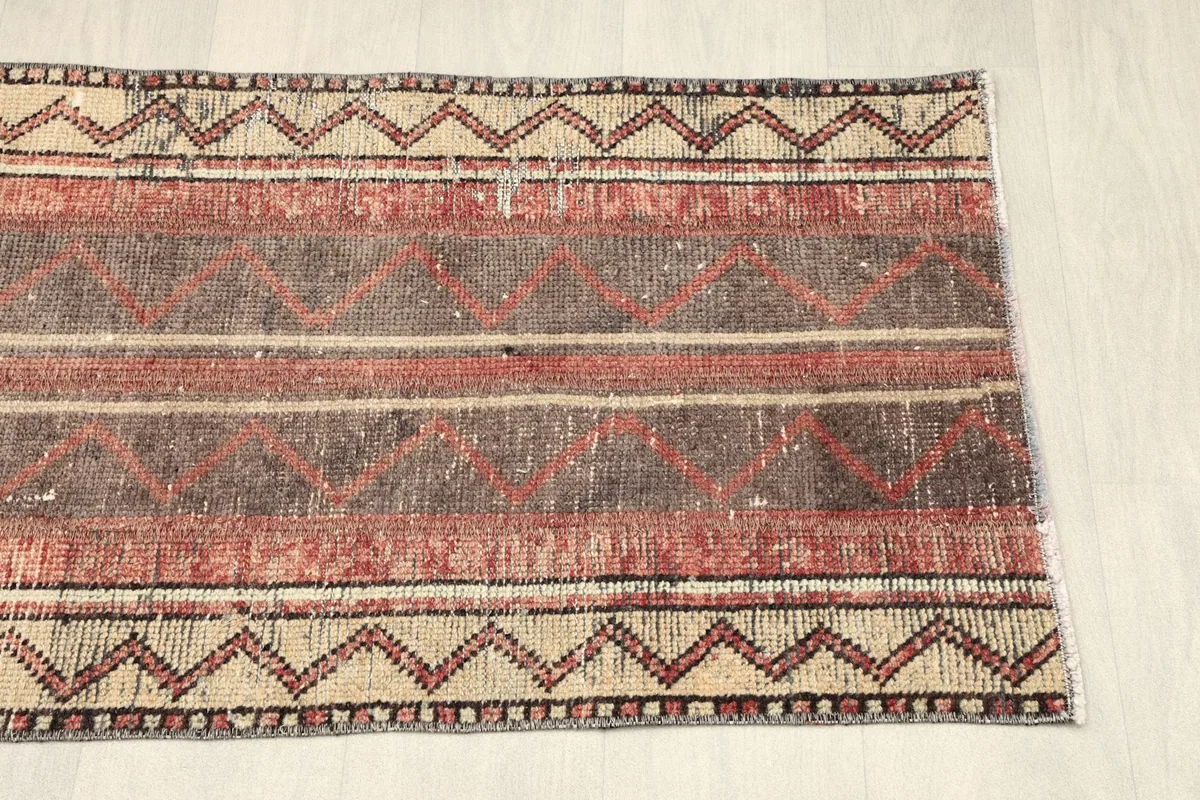 Another partial view of the rug, showcasing the vintage patina and color variation.