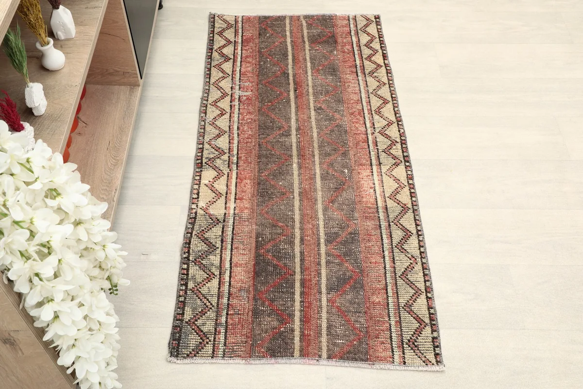 Overhead view of the hand-knotted wool rug, showing its full striped and geometric pattern.