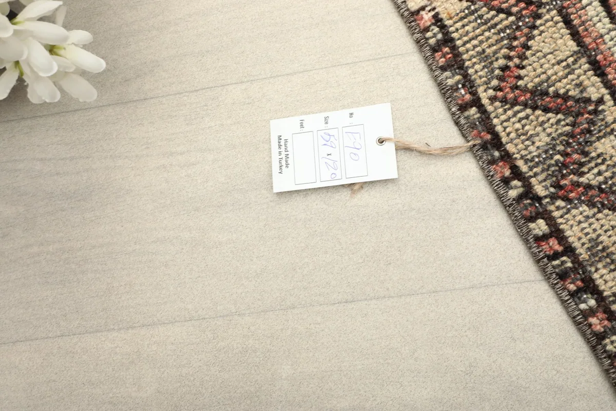 Corner of the rug with a product tag, set against a light-colored floor.