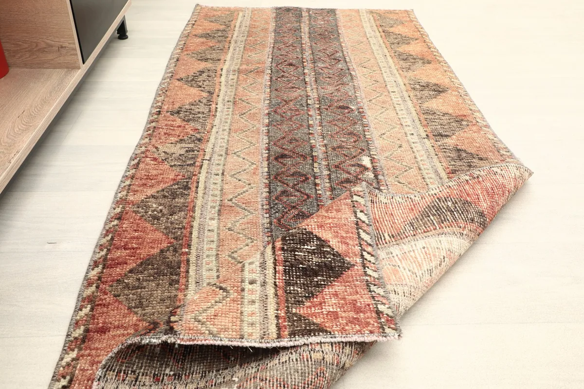 The runner rug partially folded, illustrating its flexibility and the overall design from an angle.