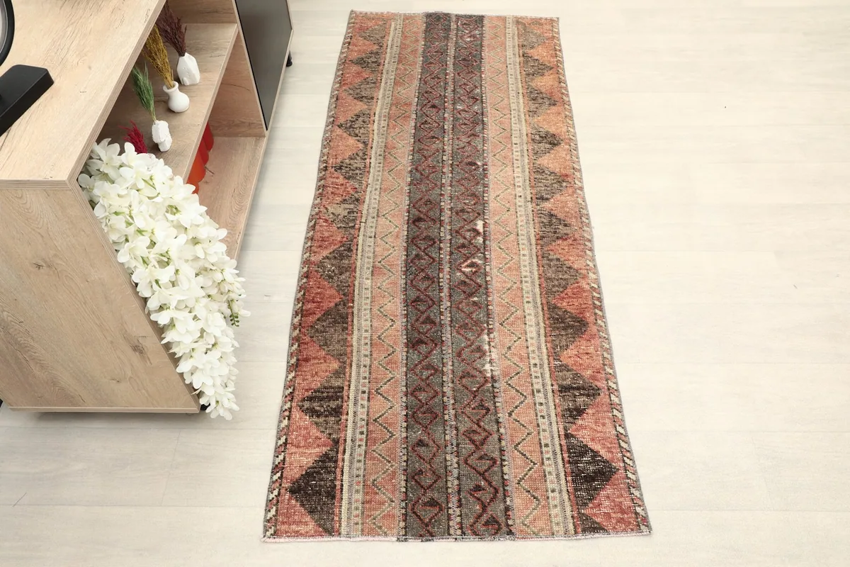 Overhead view of the hand-knotted runner rug, showcasing its full length and striped geometric patterns.