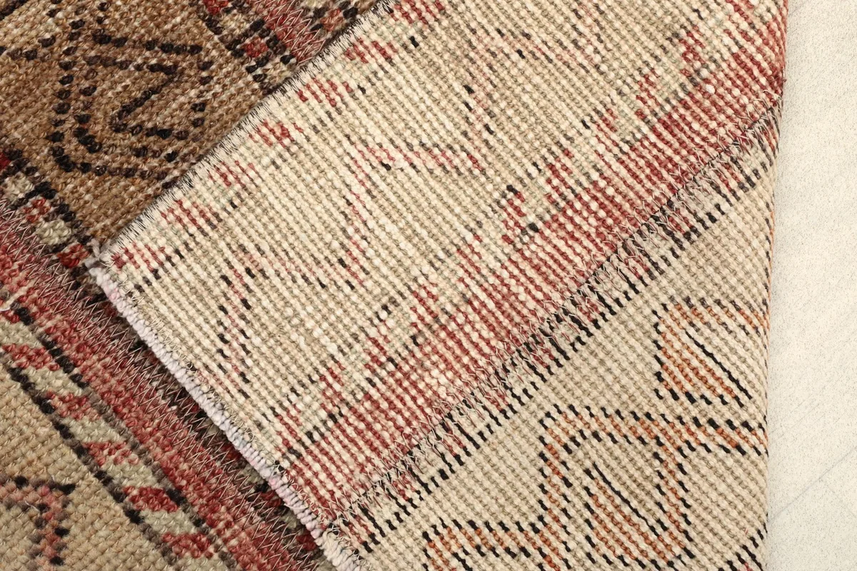 View of the rug's back, revealing the hand-knotted cotton foundation