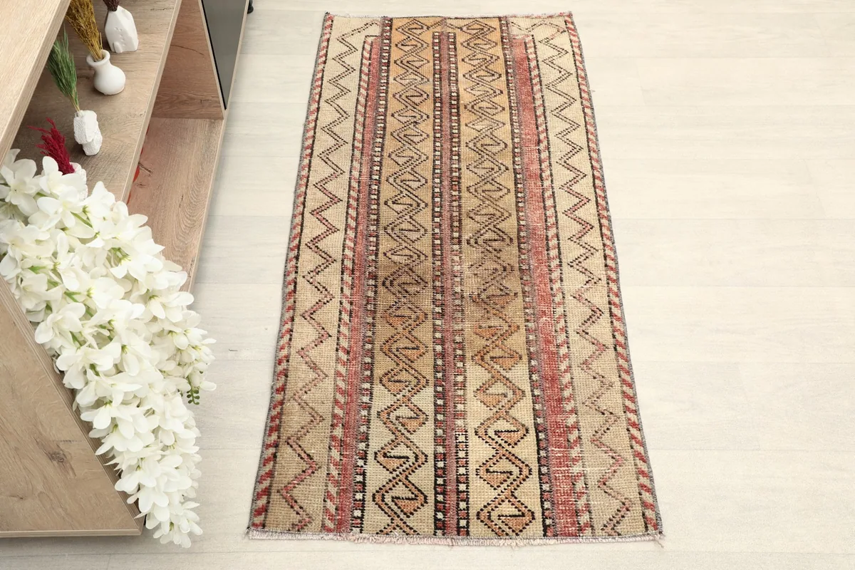 Overhead view of the hand-knotted vintage rug showcasing its striped tribal pattern