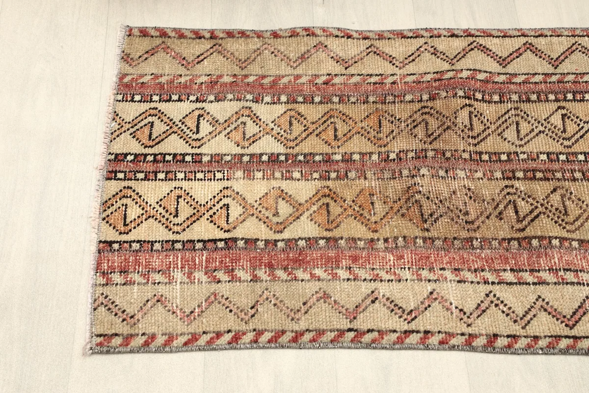 Partial overhead view of one end of the rug, highlighting its striped design