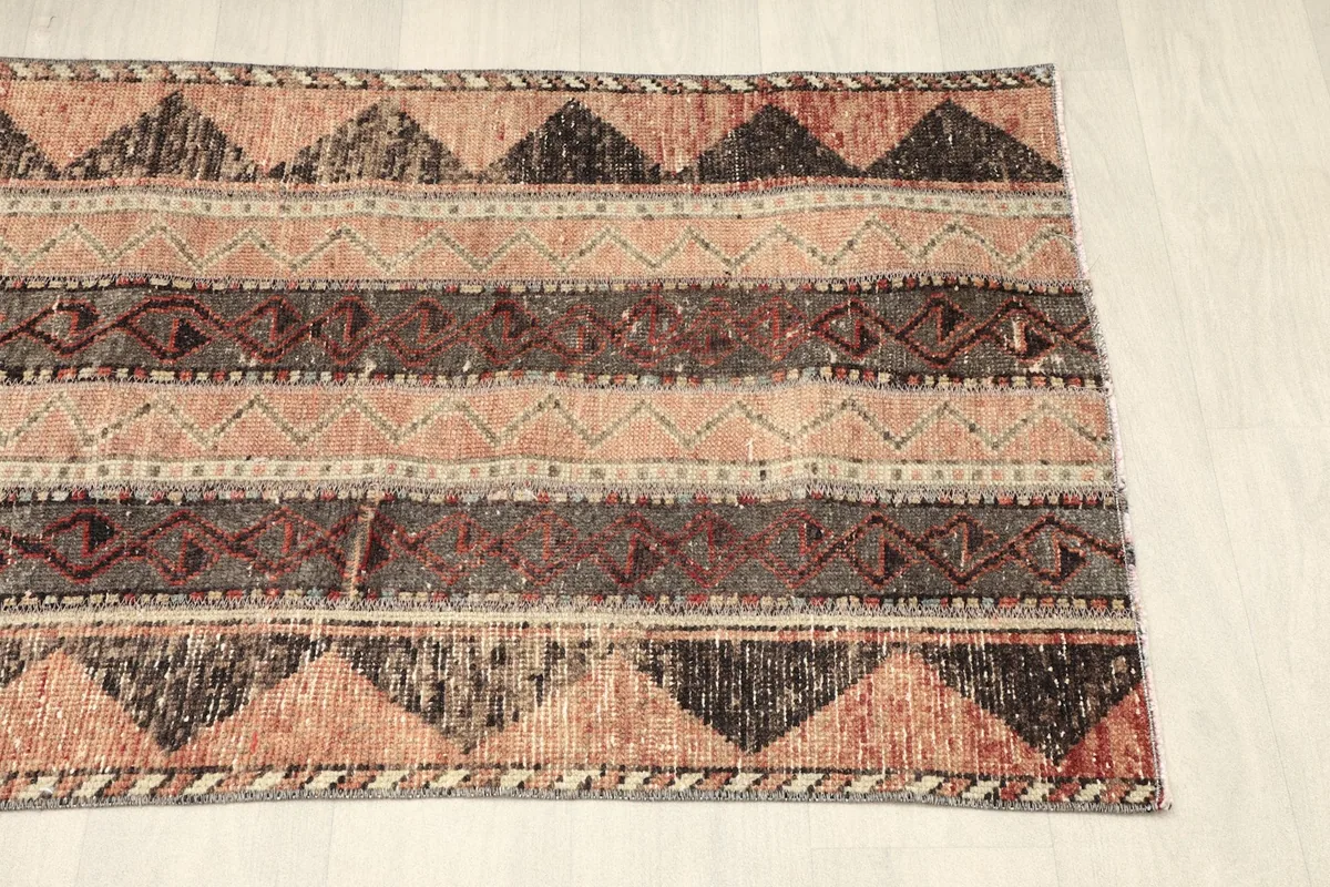 View from the opposite end, revealing the continuation of the rust and black geometric patterns.
