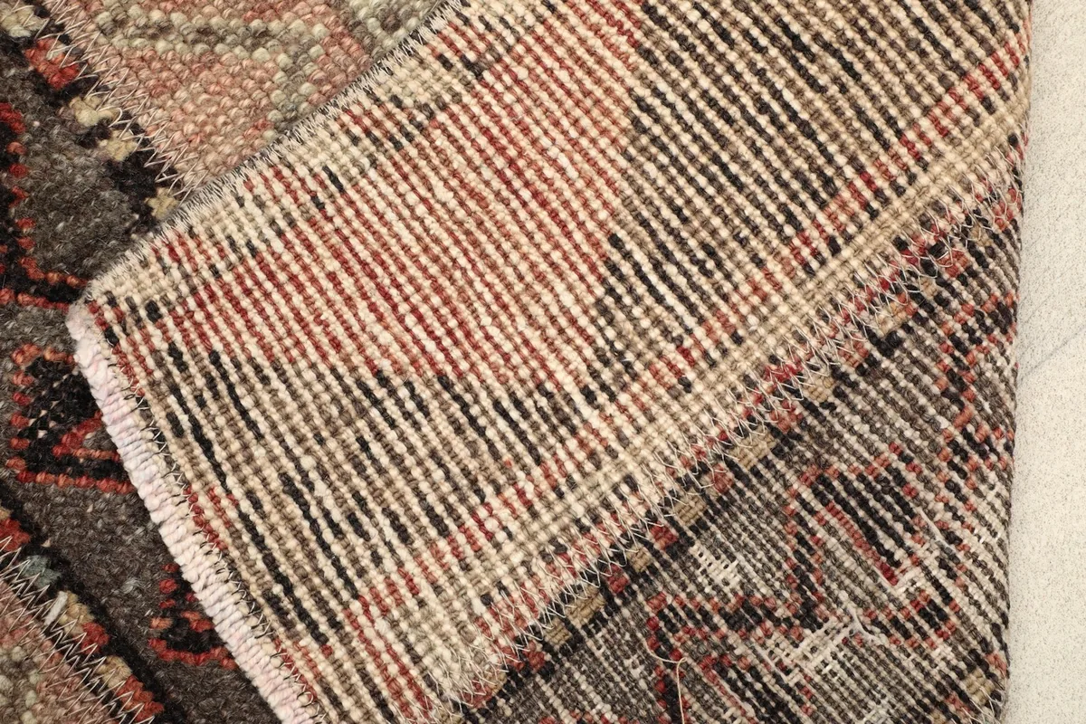 View of the rug's reverse side, showing the tightly hand-knotted wool pile on cotton foundation.