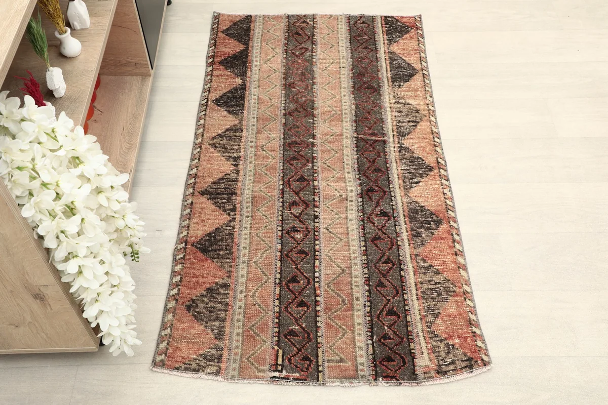 Overhead view of the hand-knotted rug, highlighting the full length of its geometric and striped design.
