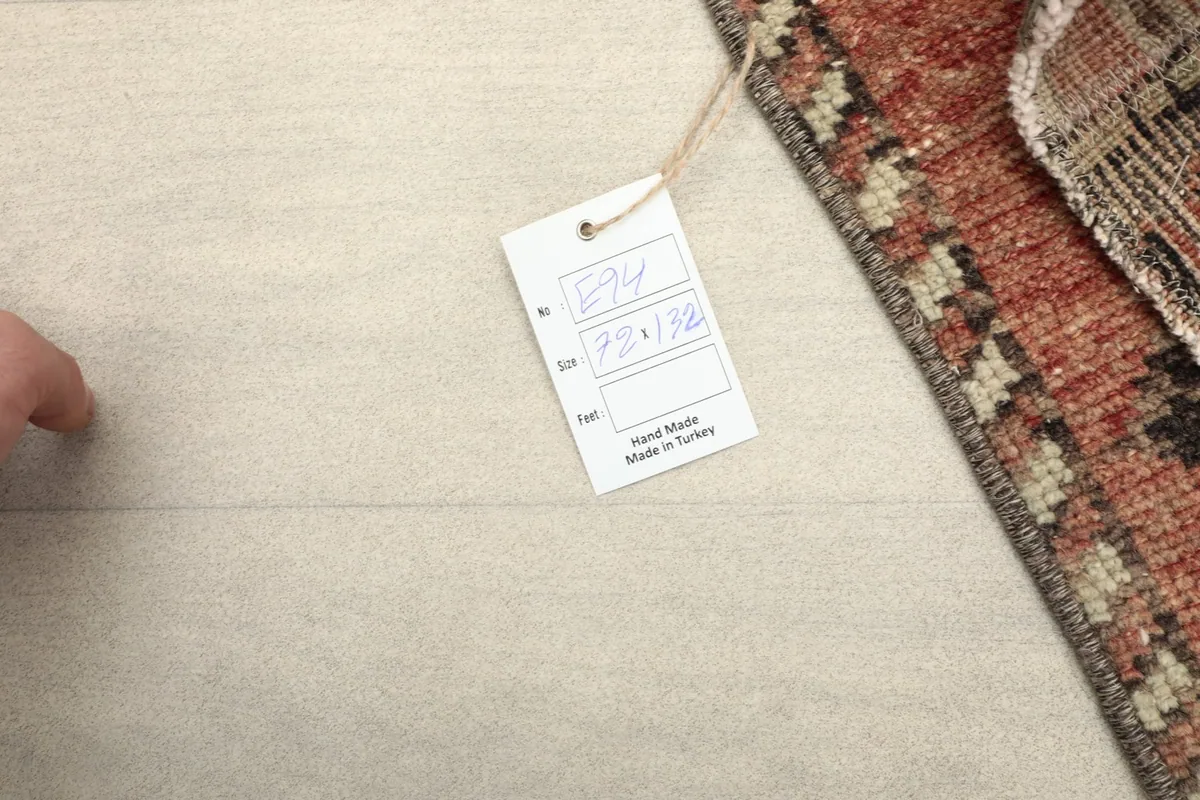 Tag showing the rug's dimensions (72 x 132 cm) and origin, confirming it is hand-made in Turkey.