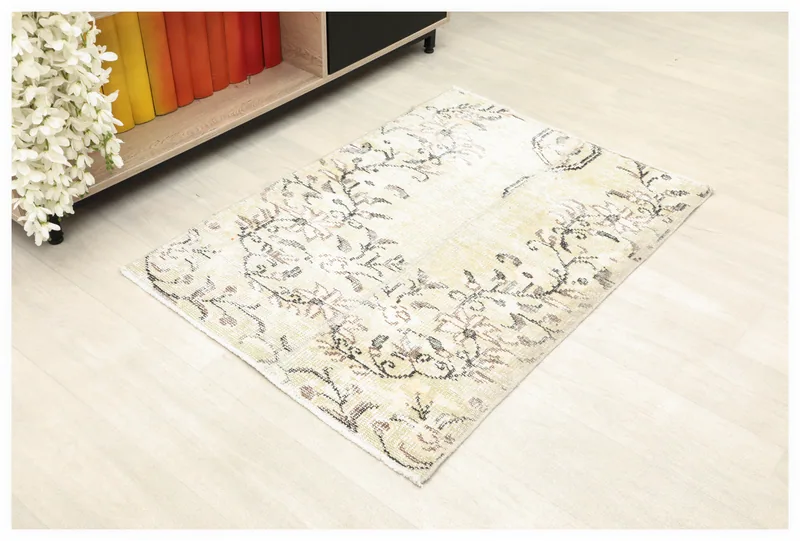 Full top view of the 2'6" x 3'7" ivory vintage Anatolian rug with floral motifs on a white background