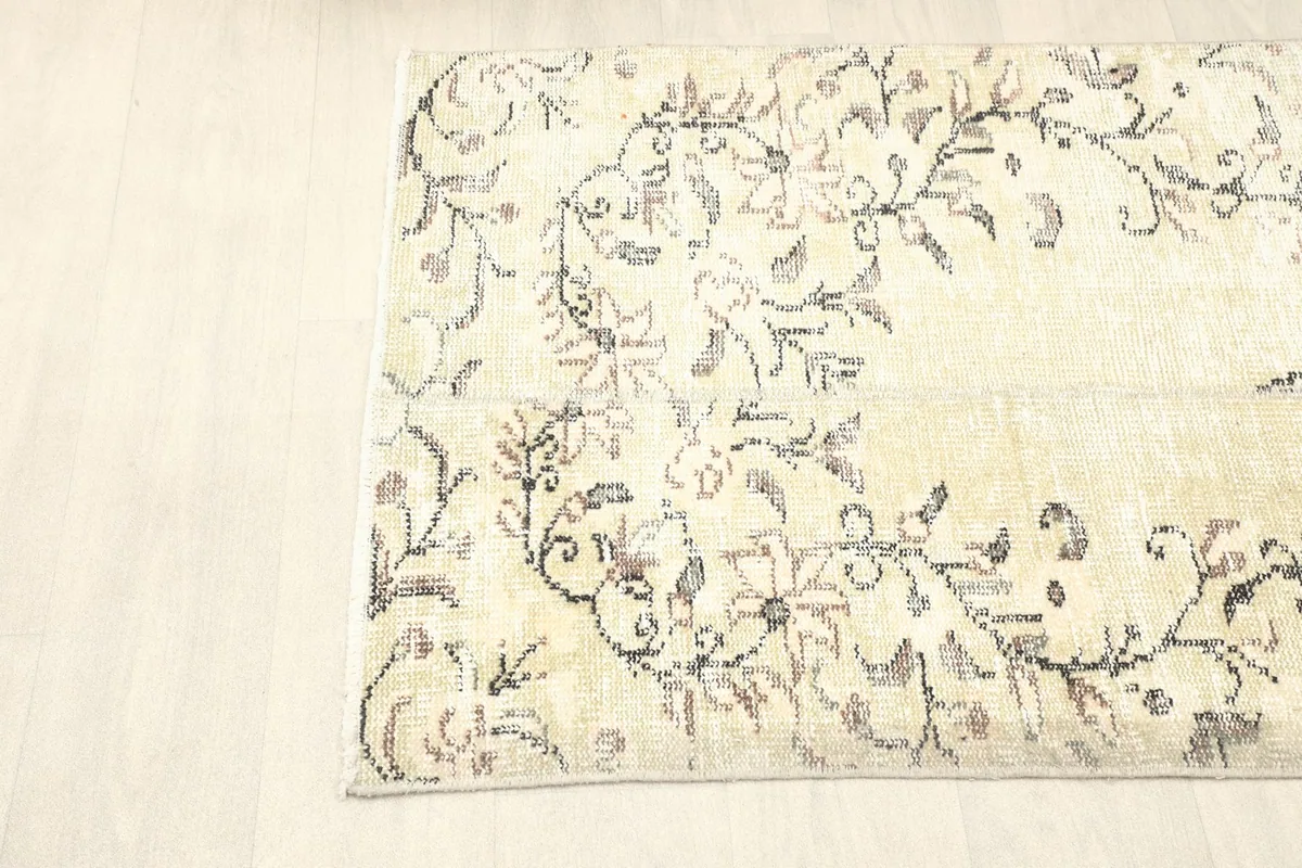 Side angle of the rug, emphasizing its compact size and subtle color variations