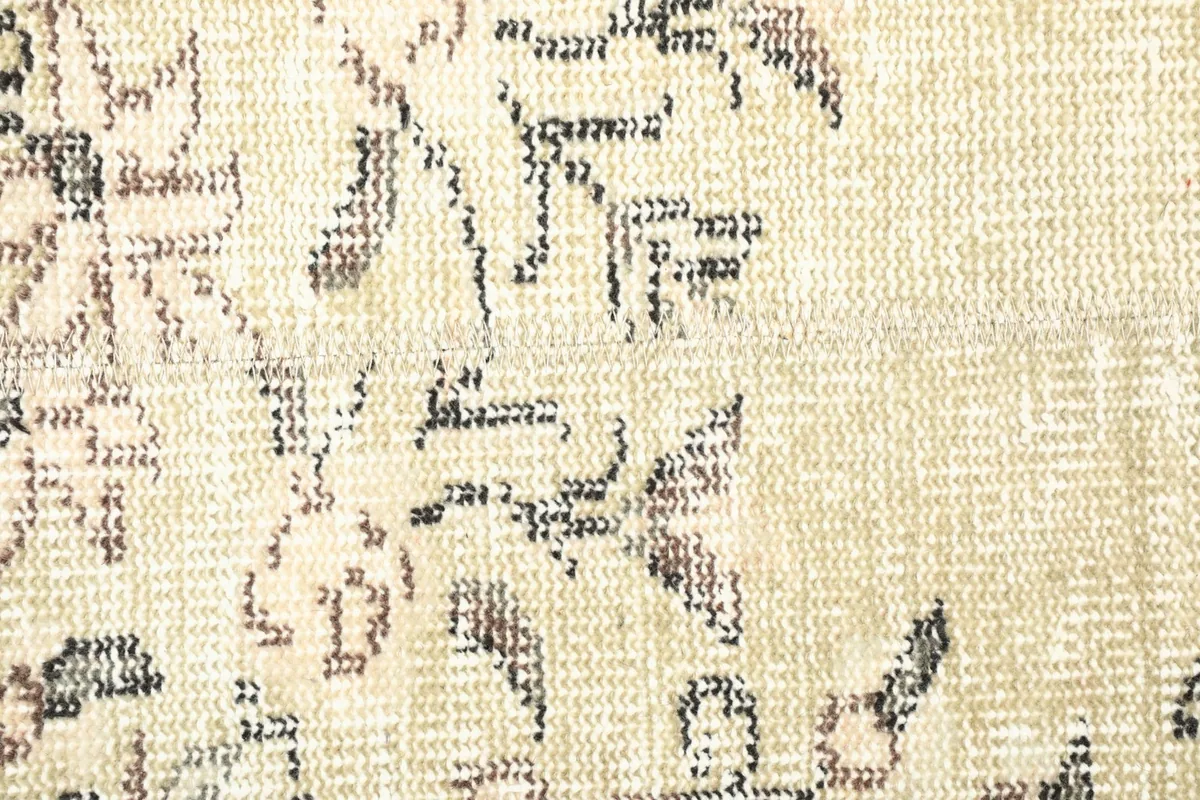 Detailed view of the low wool pile texture and the intricacy of the hand-knotted design
