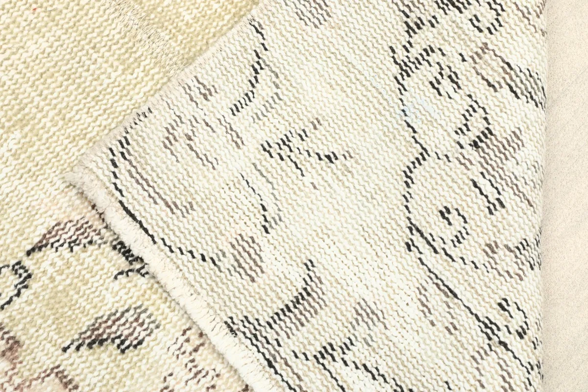 View of the rug's reverse side, revealing the cotton foundation and fine hand-knotting