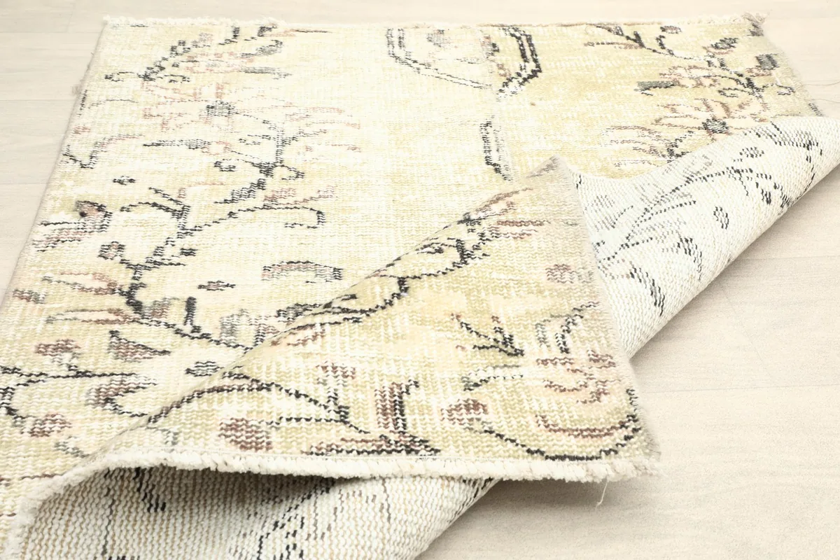 The rug folded to show its flexibility and the consistent pattern on both sides