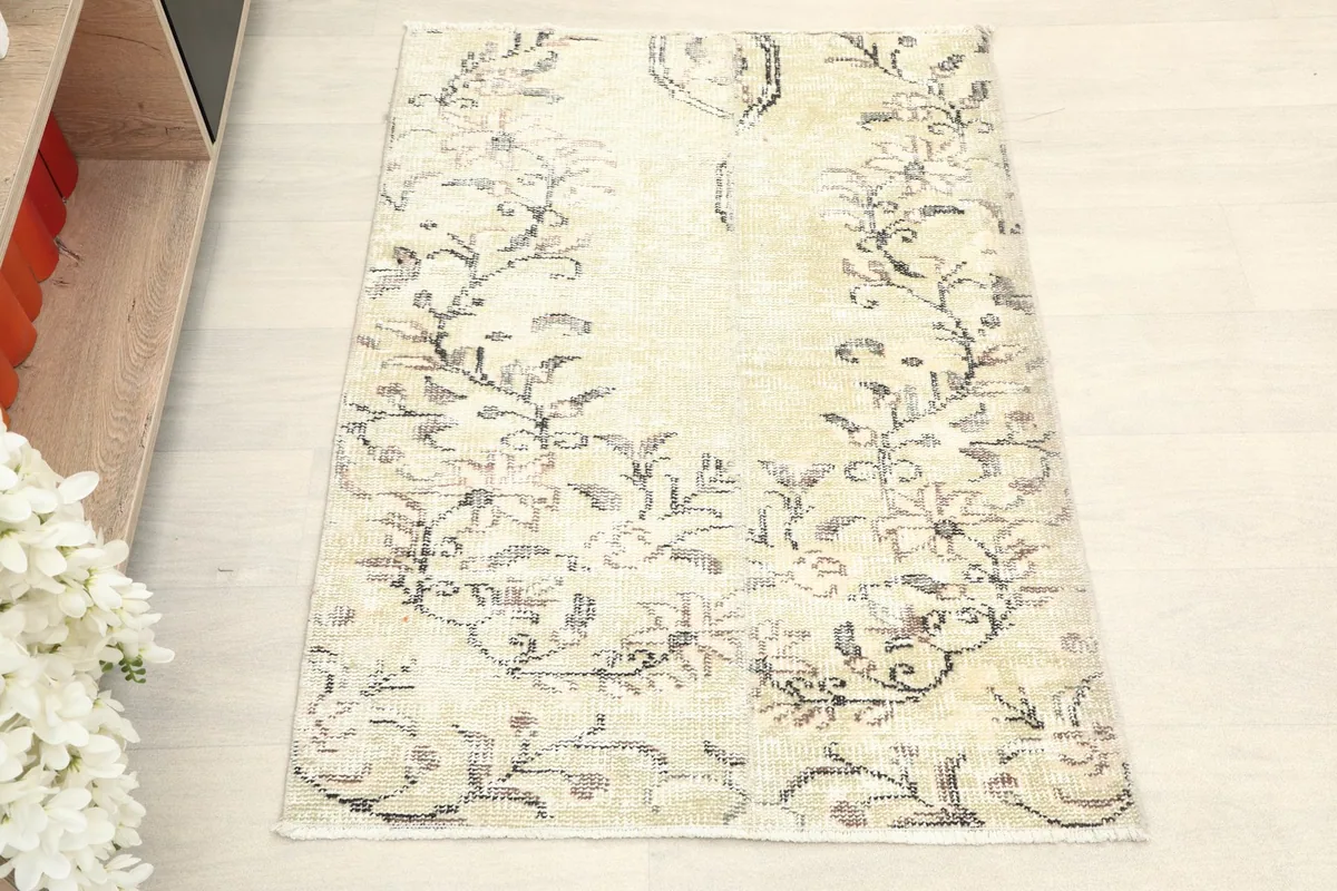 Overhead view of the ivory vintage wool rug showcasing its full pattern and soft colors