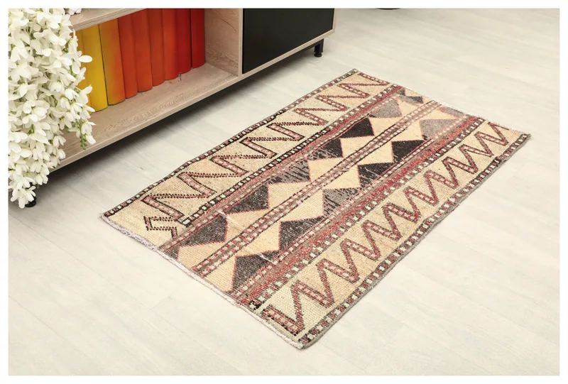 Full top view of the vintage Anatolian beige tribal geometric area rug on a light floor
