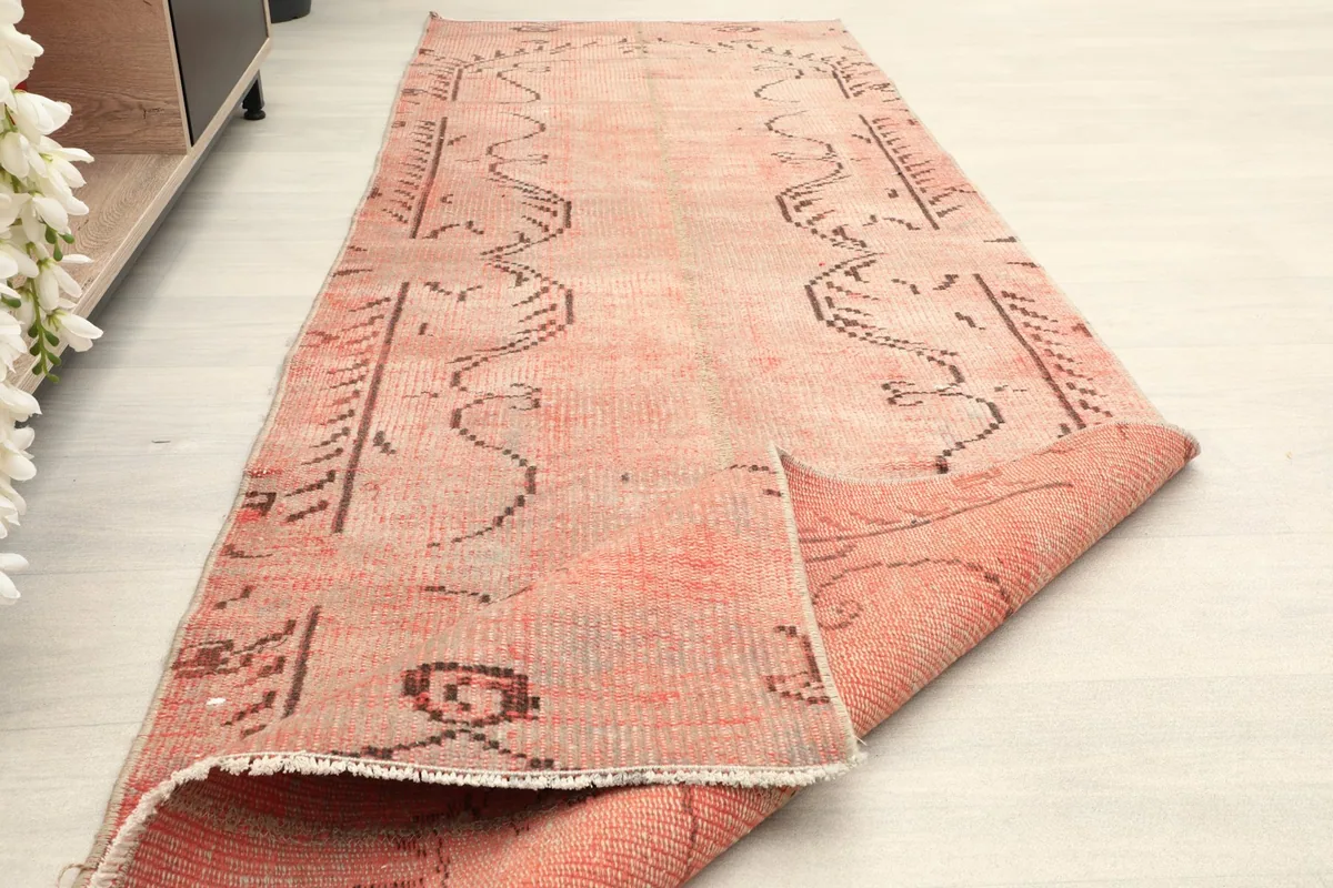 The runner partially rolled, showing its presence in a styled room setting next to furniture.