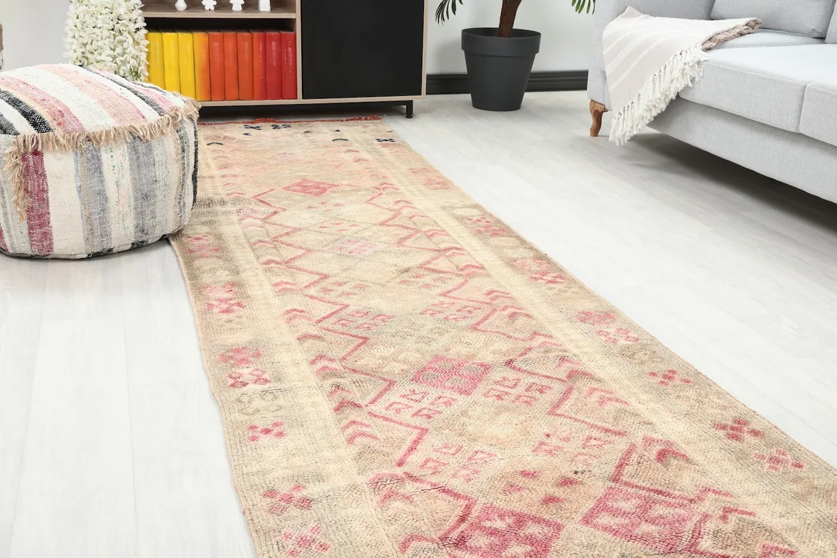 Close-up angle of the runner rug showing the geometric motifs and soft colors