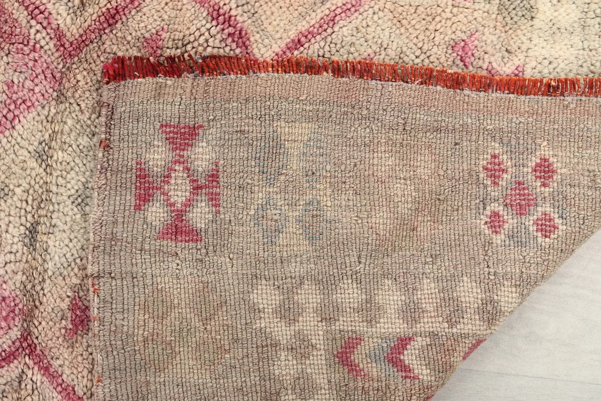 Close-up of the rug's reverse side, revealing the hand-knotted construction and foundation