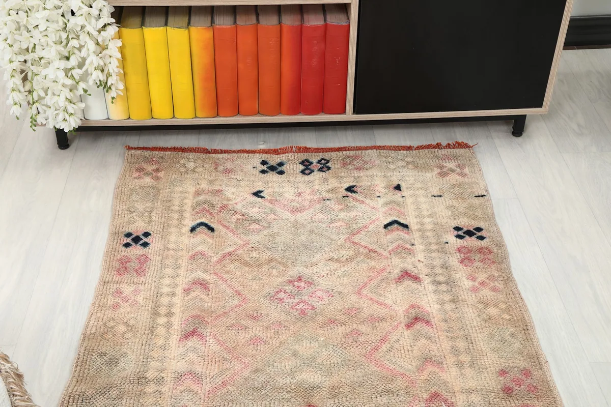 Overhead view of one end of the runner rug, showing the distinct patterns and fringe